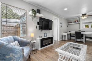 a living room with a couch and a tv at 3 Bedroom Gulfport Rental by Next Step Property Management in Gulfport