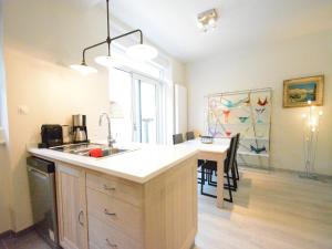 a kitchen with a sink and a counter with a table at Riverside Villa in Bouillon in Bouillon