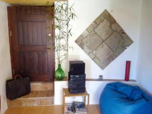 a living room with a blue couch and a door at Vivenda Familia Pedro in Vila do Bispo
