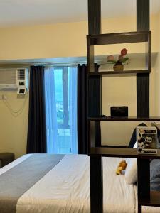 a hotel room with a bed and a window at Modern & Cozy Homey Condo in Avida Riala Towers Cebu City IT Park T1 in Cebu City