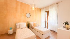 a living room with two beds and a mirror at Como Lake - Balcony, Private Parking, 2 Bathrooms in Cernobbio +27 photos