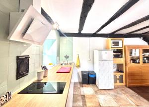 a kitchen with a sink and a refrigerator in a room at Casa Rural - La Tregua 