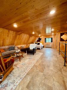 a large living room with wooden walls and wooden ceilings at Barn On The Ridge - HOT TUB - Sleeps 6 in De Soto