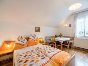 a bedroom with a large bed and a table at Apartment in Tröpolach near Ski Lift in Tröpolach