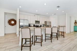 a kitchen with a table and chairs in a room at Luxury Home With Themed Rooms, Game Room And Waterpark & Resort Access Near Disney At Encore Resorts Reunion - 260Cl in Kissimmee +36 photos