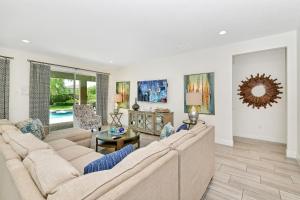 a living room with a couch and a table at Luxury Home With Themed Rooms, Game Room And Waterpark & Resort Access Near Disney At Encore Resorts Reunion - 260Cl in Kissimmee