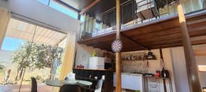 a kitchen with a table and a balcony at Chalés sol e luar in Serra do Cipo