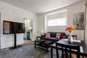 a living room with a blue couch and a tv at 3 Berkeley - 1 Bedroom Apartment, with Laundry in Berkeley