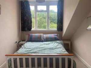 a small bedroom with a bed and a window at Newberry Beach lodge in Combe Martin