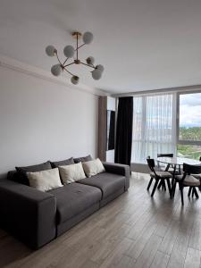 a living room with a couch and a table at Compass Apartments Елітний Житловий комплекс in Chernivtsi