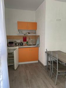 a kitchen with a sink and a table with chairs at Одесский дворик in Zatoka