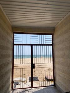 a room with a large window with a view of the beach at Одесский дворик in Zatoka