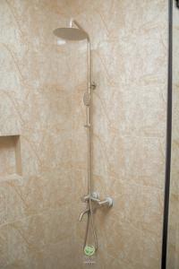 a shower with a shower head in a bathroom at Maghaz Royal Hotel in Tamale
