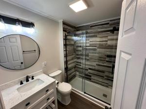 a bathroom with a toilet and a sink and a mirror at Pappy's Trail House in Rock +17 photos