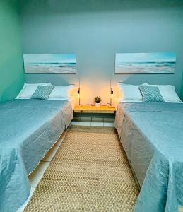 two beds sitting next to each other in a bedroom at Hostel of Santurce in San Juan