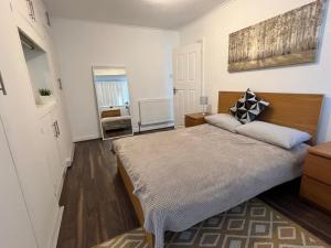 a bedroom with a large bed in a room at 3 Bedroom modern house 15 min to tube, shops near by in Finchley