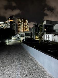 a city street at night with buildings in the background at Jumeriah palms resort in Mombasa