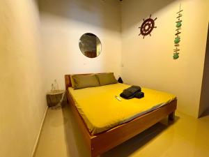 a bedroom with a bed with yellow sheets and a mirror at Sliema Room with ensuite bathroom, air-condition and spacious in Sliema