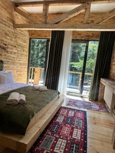 a bedroom with a large bed and a fireplace at ECHIVITI Cottages in Abastumani in Abastumani