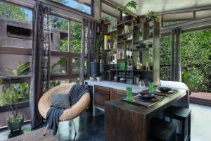 a living room with a desk and a table at Riptide Lodge in El Paredón Buena Vista