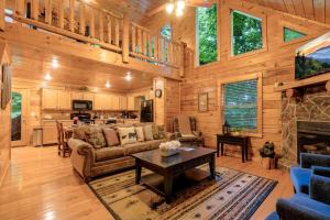 a living room with a couch and a fireplace at Rosey Bear cabin in Pittman Center