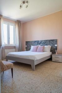 a bedroom with a large bed with pink pillows at La casa di AnNa in Cervesina
