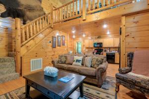 a living room with a couch and a table at Rosey Bear cabin in Pittman Center