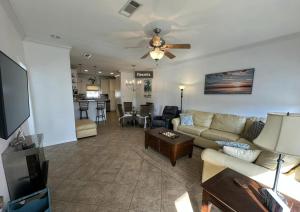 a living room with a couch and a table at Steps from the Sand and Town Green - 2BR Coastal Retreat in Long Beach