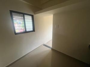 an empty room with a window on the wall at Saraswati Enclave in Alandi