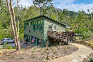 a green house with a deck in the woods at Appalachian Mtn Retreat 4 Mi to Grovewood Village in Asheville