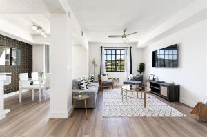a living room with a couch and a table at Remodeled Townhome with Pool & Lake Views in Gated in Delray Beach