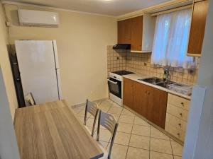 a kitchen with a table and a refrigerator at Loft Azure-Karfas in Chios +11 photos