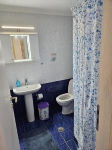 a bathroom with a sink and a toilet at Loft Azure-Karfas in Chios