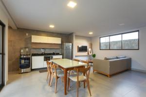 a kitchen and dining room with a table and chairs at Mar de Tabatinga #B3 - Estilo e lazer by Carpediem in Conde