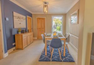 a dining room with a table and chairs at Coastal home sleeping five - 2 minute walk beach in Pakefield