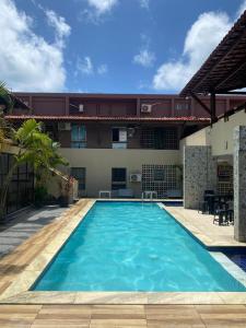 a large swimming pool in front of a building at Enseadas dos corais in Cabo de Santo Agostinho