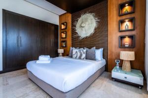 a bedroom with a large white bed and wooden walls at Penthouse d'Exception, Terrasse et Piscine Privée in Bouznika