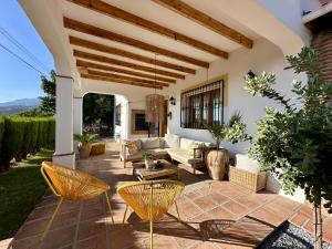 a living room with a couch and chairs on a patio at Bed & Breakfast Casa del Palta in Canillas de Albaida