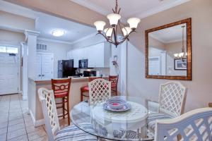 une salle à manger et une cuisine avec une table et des chaises en verre dans l'établissement Litchfield 1BR Getaway at Seaside Inn, à Pawleys Island 25 autres photos