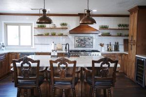 a kitchen with a counter with chairs and a sink at Villa on 5 Acre Vineyard Equestrian Estate, Pool & Hot tub, Events in Murrieta