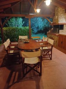 a wooden table and chairs on a patio at Elios Villa Chalkidiki in Skala Fourkas