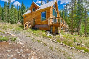 a log cabin in the woods on a hill at Private Deck Secluded Fairplay Cabin in Fairplay