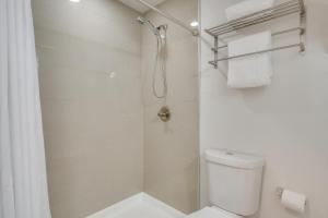 a white bathroom with a shower and a toilet at Private Deck Secluded Fairplay Cabin in Fairplay +21 photos