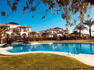 a large swimming pool in front of some houses at Brisa Azul in Playas de Vera