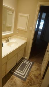 a bathroom with a sink and a mirror at Spacious Retreat for Crews, Corporates & Families in Houston +23 photos