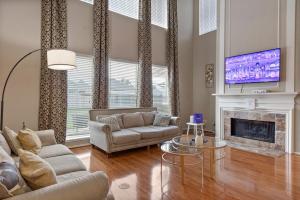 a living room with a couch and a fireplace at Spacious Retreat for Crews, Corporates & Families in Houston