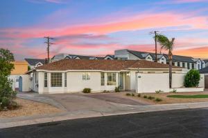 a house with a driveway in front at Bray House - Epic Shared Backyard - Pool - Games in Phoenix