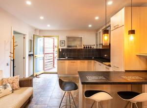 a kitchen with a counter and chairs in a room at Luxury 3 Beds Villa Inside Resort in Estepona