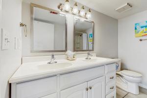 a white bathroom with a sink and a toilet at Emerald Surf 206 in Navarre +18 photos