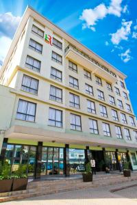 a large white building with a sign on it at Hotel Rio in Nairobi